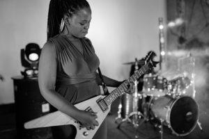 A girl playing guitar on stage