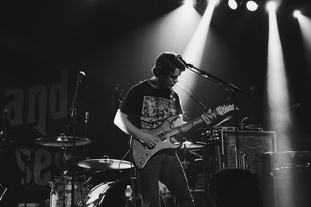 A rockstar on stage playing guitar